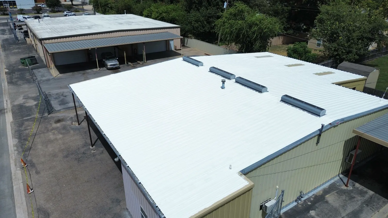 A coated low slope commercial roof in Waco, seen from above