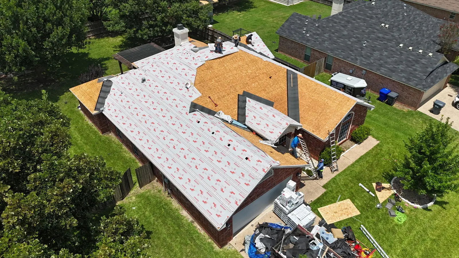 Exposed roof decking with underlayment being laid on a Waco home, seen from above