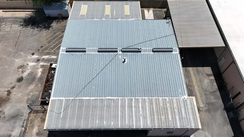 Metal roof on a commercial building with a loading area, from above