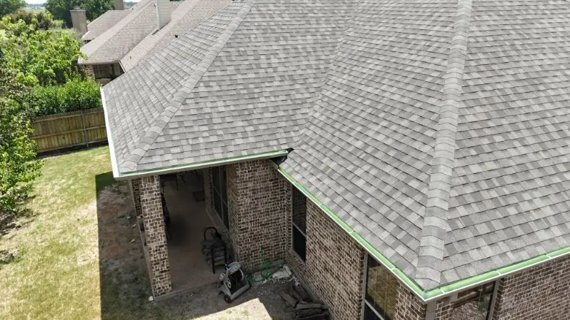 Guttering along the roof edge of a brick house, from above