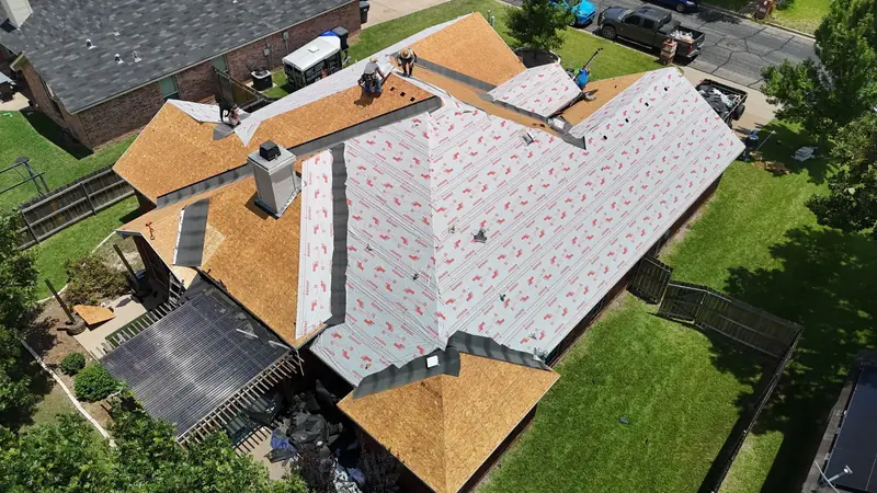 Roof stripped to the decking with underlayment going down