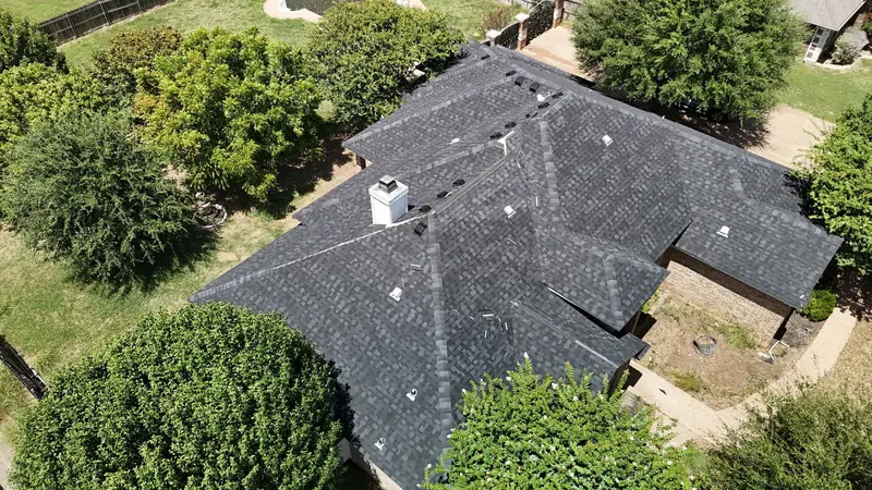 Completed shingle roof seen across the ridge, from above
