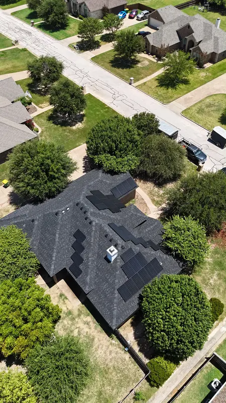 Roof mounted solar panels on a grey shingle roof, from above