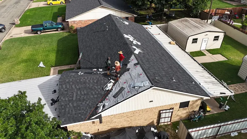 ACS crew stripping an old roof, from above