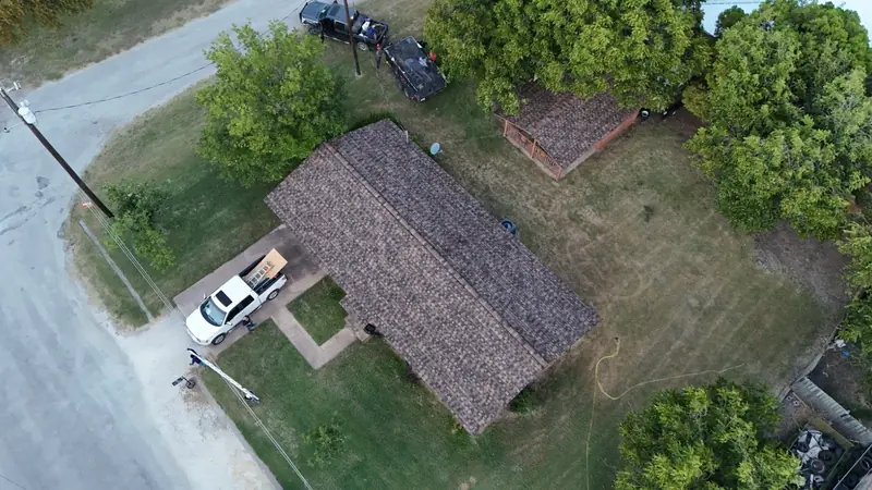 A worn roof photographed from above before replacement